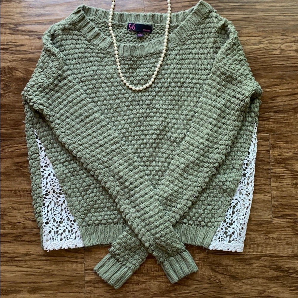 Green sweater with lace cutouts